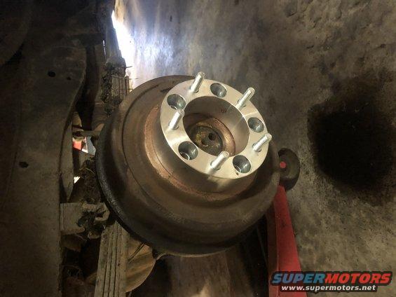 Wheel spacer with studs mounted on a vehicle's brake rotor