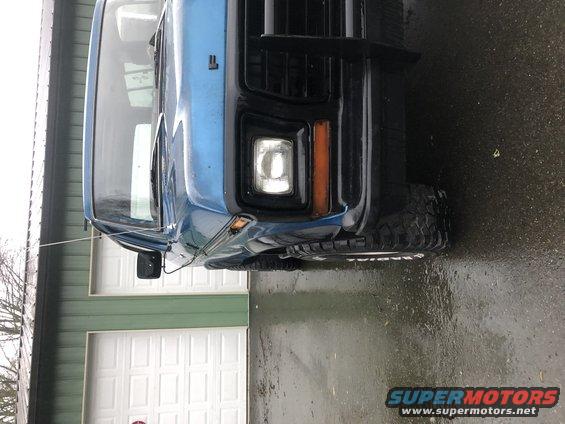 Blue 1979 Ford Bronco front corner with black grille and bumper