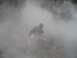 1979 Ford Bronco - A person is obscured by dense smoke, with a website logo visible in the lower right corner.