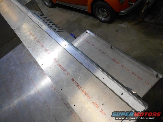 Close-up of aluminum sheeting with red stamped text.