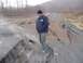 1979 Ford Bronco - A man surveys a road severely damaged by a landslide, with steam emanating from a deep fissure.