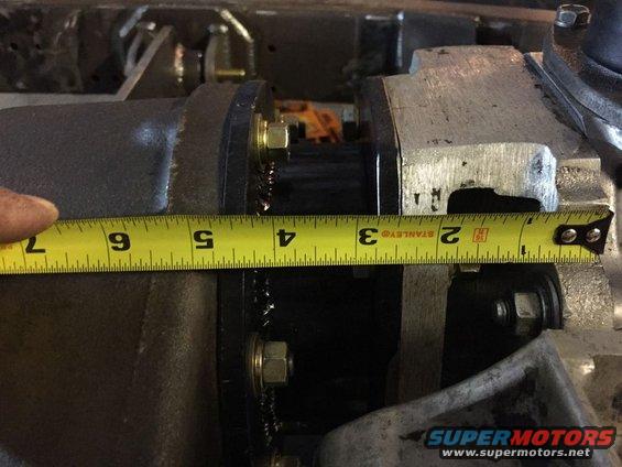 Tape measure showing approximately 4 inches on a dark metal mechanical component