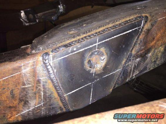Welded metal frame with white chalk marks and rust