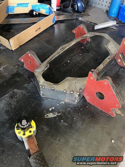 Metal bracket with welded seams and magnetic clamps on a workbench