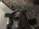 1993 Mercury Tracer - Close-up view of a welded exhaust pipe flange with threaded fittings, alongside a hammer.