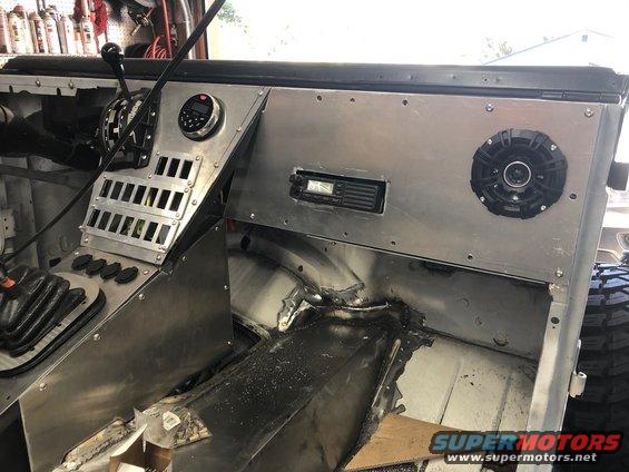 Custom aluminum dash with shifter, radio, and speaker. Floor is bare metal