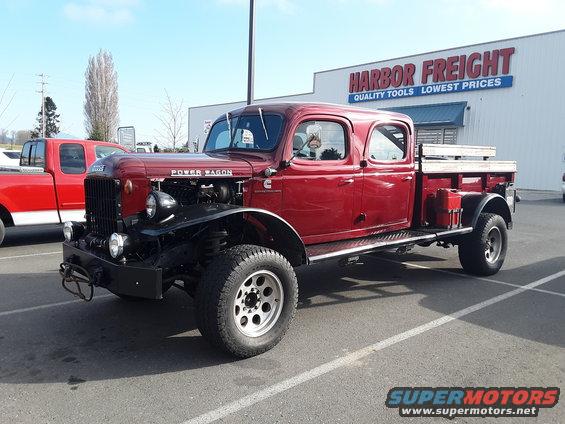 Red four-door pickup truck with 'Power Wagon' badging and a flatbed