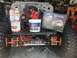 1992 Jeep Wrangler - A Jeep Wrangler chassis is shown with its engine and various automotive products laid out around it.