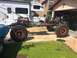 1992 Jeep Wrangler - The chassis of a Jeep is shown with its engine and massive off-road tires, suggesting a custom build or restoration project.