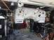 1992 Jeep Wrangler - Jeep body shell undergoing restoration, suspended in a garage with tools and parts around.