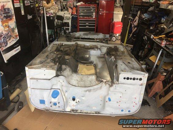1992 Jeep Wrangler tub stripped down for body work, showing bare metal and some repair patches
