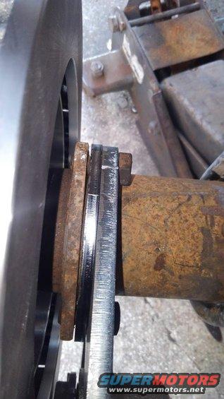 many axles need the new backing plate to be shimed out to install. on both this and my F250s kit i needed to shim it out. my F250 i stacked some washers to shim it but the kit now includes a spacer to do that. 

you will have to mock the caliper/pads/rotor up to see if the spacer is needed or not.

the stock bolts should be fine with use without the spacer but with the spacer, longer bolts will be needed. the kit does not include these bolts unfortunately