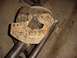 1992 Ford Bronco - A wooden jig with handwritten notes and diagrams is attached to a vehicle axle housing, likely for modification or measurement.