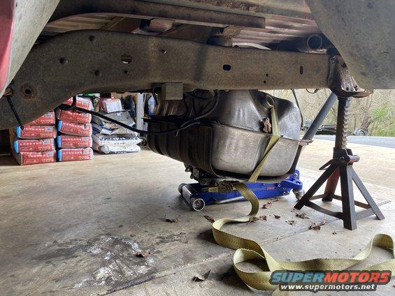 Vehicle frame and fuel tank supported by a jack and jack stand