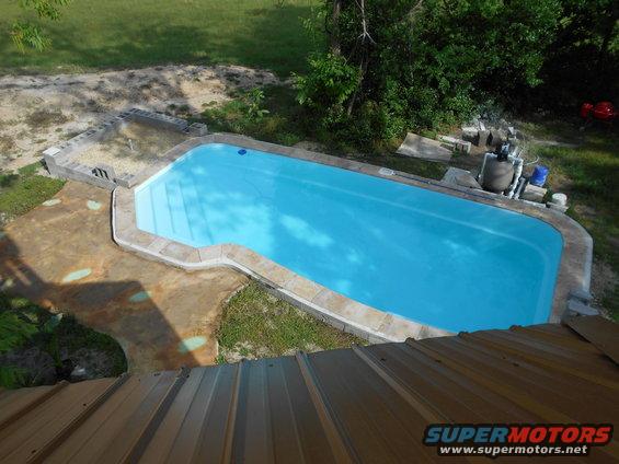 Swimming pool with blue water and concrete deck