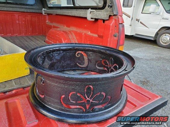 Fire pit with decorative cutouts in the bed of a red pickup truck