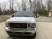2002 Ford Excursion - This white Ford Excursion, likely from the early 2000s, is shown from the front with its large tow mirrors extended.