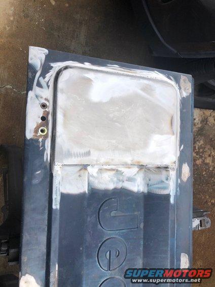 Jeep tailgate with body filler and welding repairs, showing embossed 'JEEP' lettering