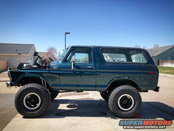 1979 Ford Bronco lifted with large tires, hood open, side view