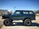 1979 Ford Bronco - This lifted 1979 Ford Bronco is shown from the side with its hood open.