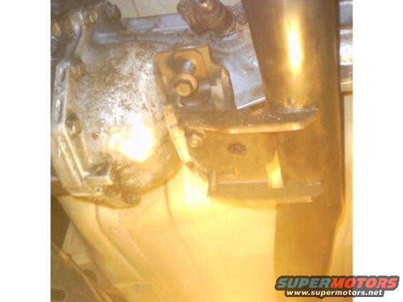 Transmission bracket attached to exhaust pipe