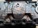 1978 Ford Bronco - Close-up view of an engine intake manifold, showing its textured surface and a central bolt head.