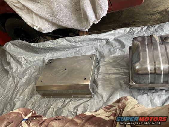 Metal fuel tank and aluminum skid plate on tarp
