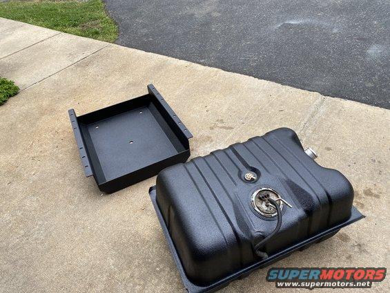 Black fuel tank and mounting bracket on concrete