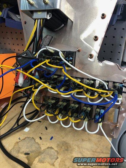 Close-up of a complex automotive wiring harness with many colored wires and connectors