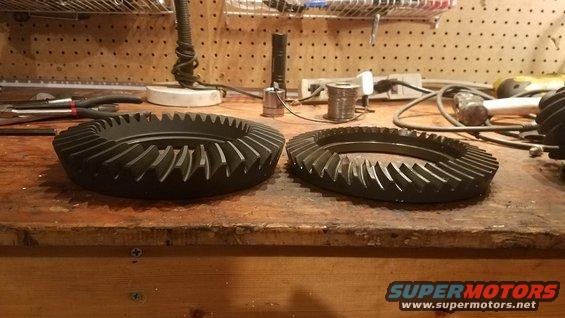 two ring gears on a workbench with tools in the background