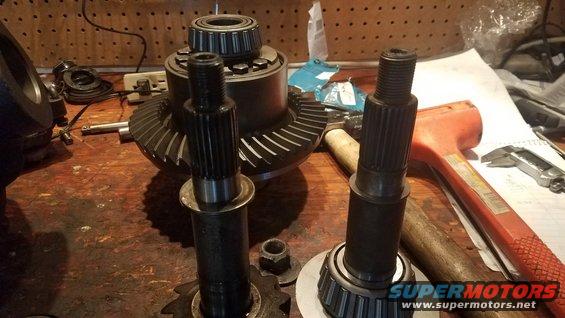 Differential gears and axles on a workbench with tools