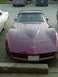 1993 Ford Bronco - Maroon Chevrolet Corvette parked in a lot, showing its distinctive front end and hood design.