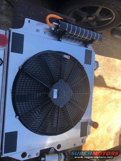 Radiator with electric fan and black oil cooler with orange hose