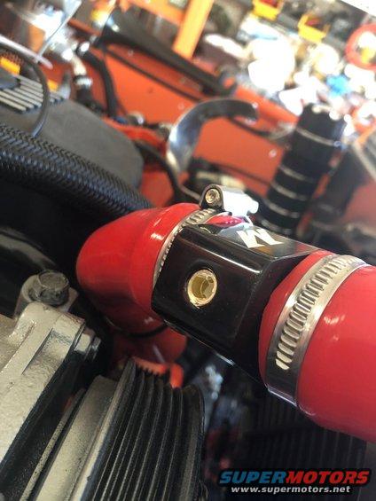 Close-up of a red hose with a K&N clamp in an engine bay