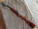 2003 Ford F-250 - An SKS rifle is displayed on a brown textured cloth, showing its wooden stock and metal parts.