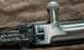 2003 Ford F-250 - Detail of a rifle's bolt action mechanism and adjustable rear sight.