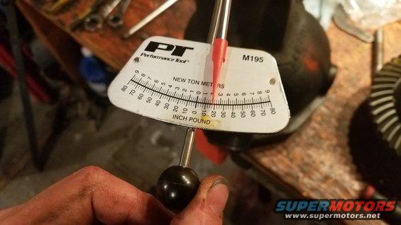 Torque wrench measuring inch pounds near a differential gear