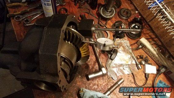 Differential assembly with dial indicator and tools on a workbench