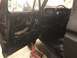 1978 Ford Bronco - The interior of a 1978 Ford Bronco is visible, with the driver's side door panel removed.