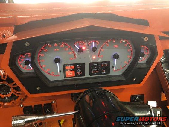 Custom dashboard gauges with red backlighting and digital displays
