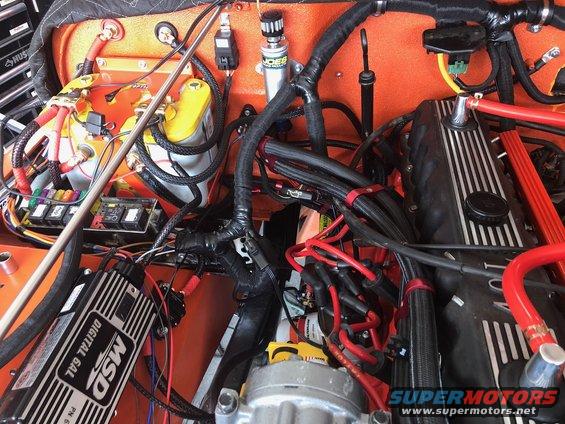 Engine bay with lots of wires, a yellow battery, and an MSD ignition box