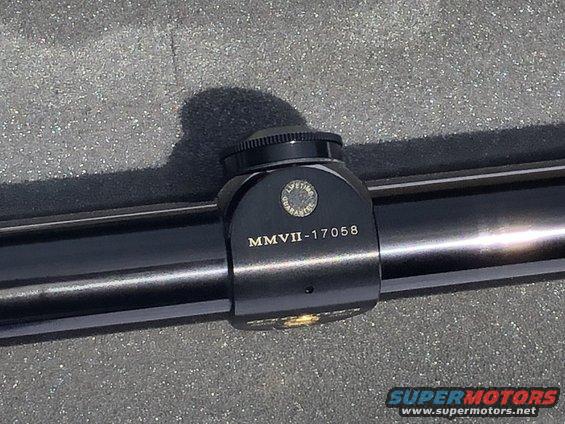Black scope mount with "MMVII-17058" and "LIFETIME GUARANTEE" text
