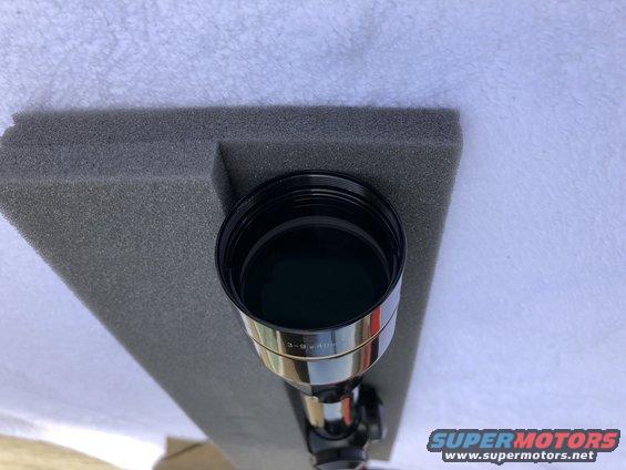 Rifle scope with 3-9x40 markings, sitting in gray foam padding