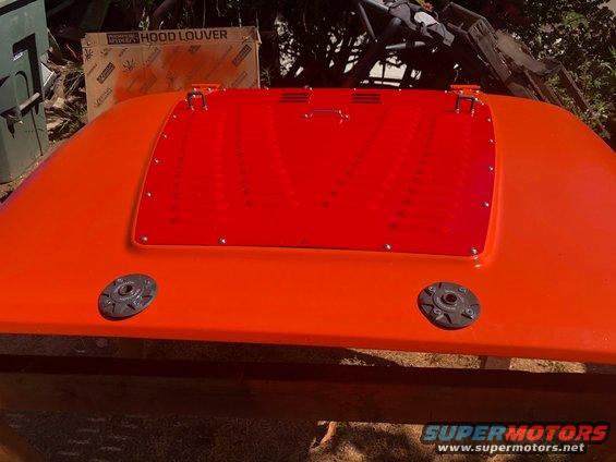 Orange hood with red louvered insert and two black latches