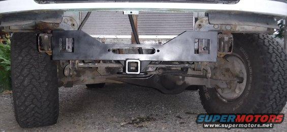 Painted and installed.  It's actually pretty easy to mount up without the use of a jack (or helper) with the tow hooks off.  It doesn't budge with just the bumper bolts through the tabs, not even fastened down.

This angle gives the best indication of ground clearance.  The receiver sits slightly lower than the tow hooks.