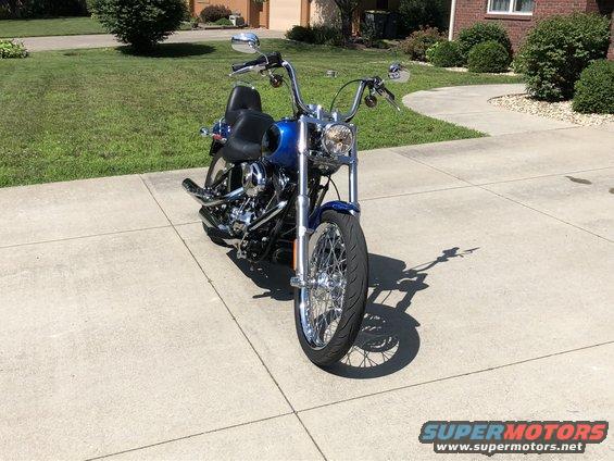 Blue 2008 Harley-Davidson Softail motorcycle parked on a concrete driveway, front view