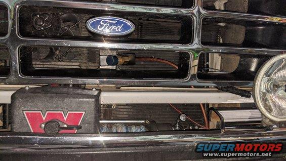 Engine bay with various hoses and components visible