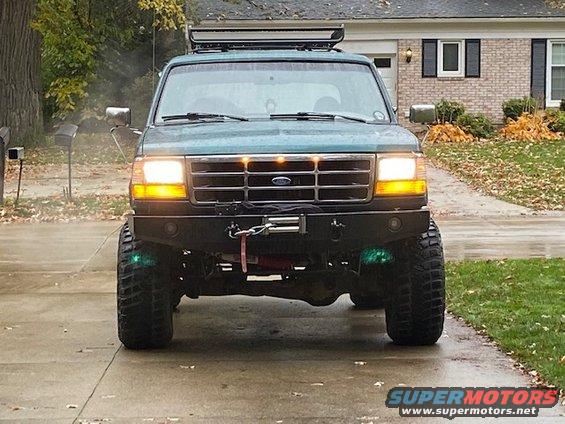 Green 1996 Ford Bronco front view with winch and aftermarket bumper