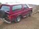 1994 Ford Bronco - Maroon 1994 Ford Bronco sits on a dirt road near a construction site.