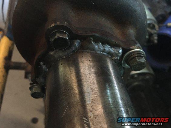 Exhaust pipe connection with hex bolts and visible welds